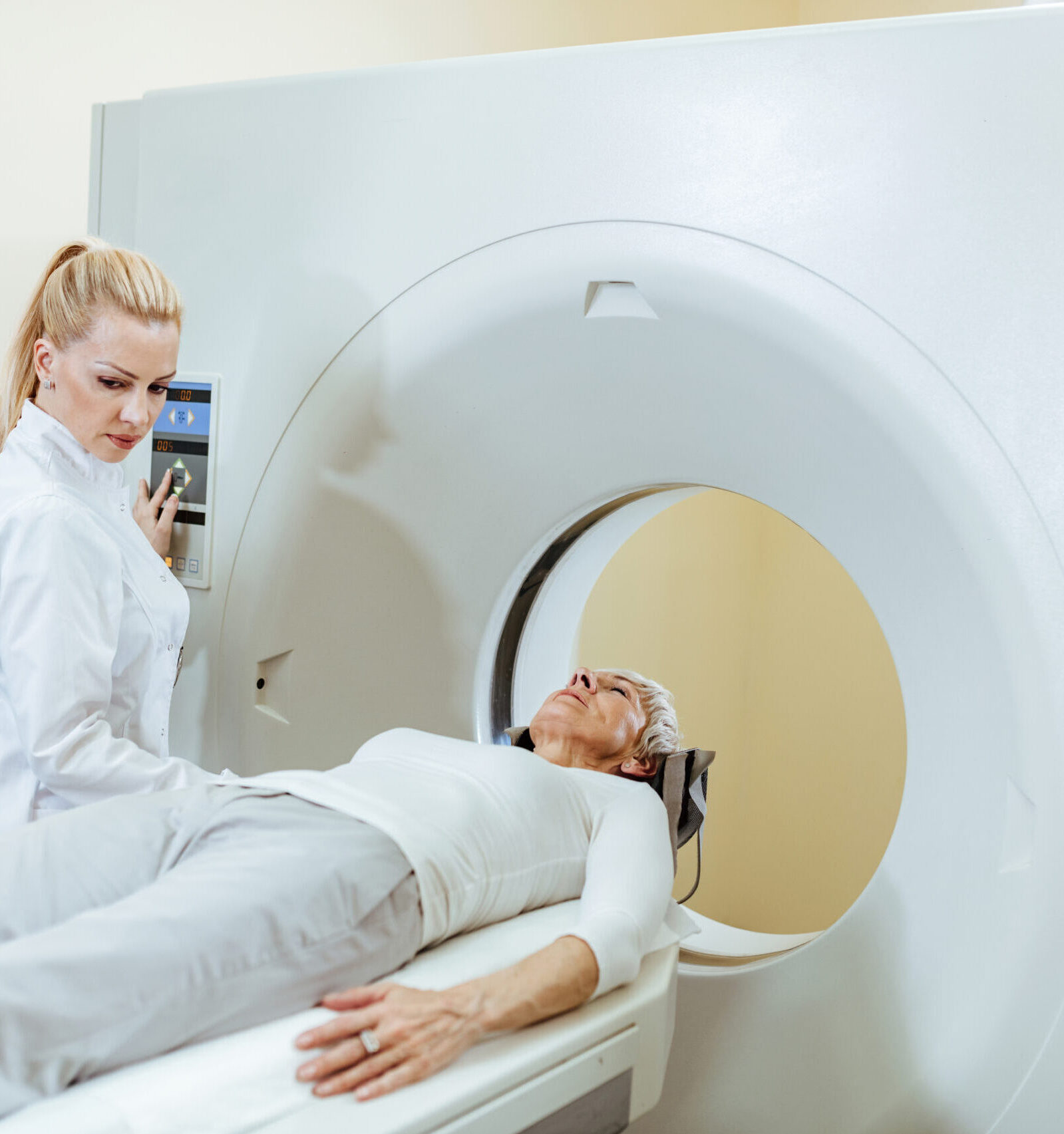 female medical technician mature patient during ct scan procedure examination room hospital 1 scaled e1675155483222